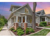 Charming two-story home with gray siding, brick accents, and a welcoming front porch at 1830 Wickford Pl, Charlotte, NC 28203