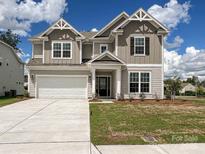 Charming two-story home with a manicured lawn, a two-car garage, and a welcoming front entrance at 2046 Sabra St # Cwo0006, Gastonia, NC 28054