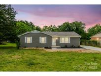 Charming single-story home featuring a brick facade, white trim, and a well-manicured lawn at 2511 Linwood Rd, Gastonia, NC 28052