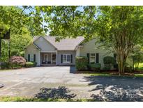 Charming single-story home with manicured landscaping and a spacious driveway at 327 Wilby Dr, Charlotte, NC 28270
