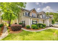 Charming townhouse showcasing manicured landscaping, a welcoming walkway, and neutral siding at 328 Rose Garden Ct, Rock Hill, SC 29732