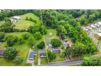Expansive aerial view of the property showcasing its natural surroundings and proximity to neighborhood at 3700 Nevin Rd, Charlotte, NC 28269