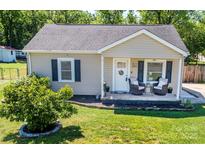 Charming single-story home with a cozy front porch and well-maintained lawn at 407 Orchard Ln, Belmont, NC 28012