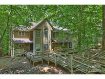 Inviting exterior of a multi-story home featuring a beautiful wooden walkway and lush greenery at 6016 Gray Gate Ln # C, Charlotte, NC 28210