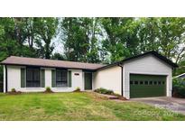 Charming single-story home with a well-manicured lawn and a two-car garage at 7228 Rollingridge Dr, Charlotte, NC 28211