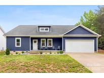 Charming blue home with a covered front porch, white trim, and an attached two car garage at 7683 Sarah Dr, Denver, NC 28037
