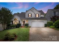 Charming two-story home featuring a manicured front lawn, inviting entrance, and attached two-car garage at 8605 Tamarron Dr, Charlotte, NC 28277