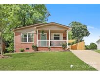 Charming brick home with a well-manicured lawn, inviting front porch, and lovely curb appeal at 906 Eastwood Dr, Rock Hill, SC 29730