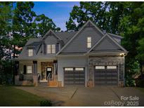 Charming two-story home with a welcoming front porch and a two-car garage at 9712 Worley Dr, Charlotte, NC 28215