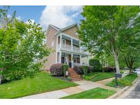 Charming two-story home with a welcoming porch and beautifully landscaped front yard, blending classic charm with modern curb appeal at 16425 Spruell St, Huntersville, NC 28078