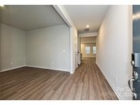 Bright living room boasts hardwood floors and neutral paint scheme at 1983 Paddlewheel Dr, Stanley, NC 28164
