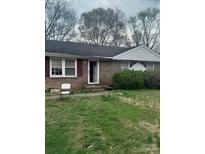 Cozy single-story brick home featuring a well-kept lawn and traditional architectural details at 2324 Knight Dr, Gastonia, NC 28052