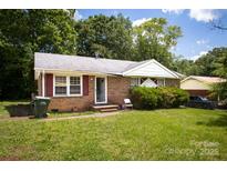 Charming brick home with a well-manicured lawn and traditional design elements at 2324 Knight Dr, Gastonia, NC 28052