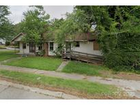 A charming one-story home with a front yard needing some TLC at 306 E Arch St, Lancaster, SC 29720
