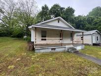 Charming home featuring a cozy front porch and a well-maintained lawn at 415 Orange St, Shelby, NC 28150