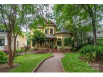 Charming Victorian home with a brick pathway and lush green lawn at 416 E Park Ave, Charlotte, NC 28203