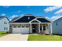 Beautiful single-Gathering home featuring stone accents, a two-car garage, and a well-manicured front yard at 417 Bent Burr Crk, York, SC 29745
