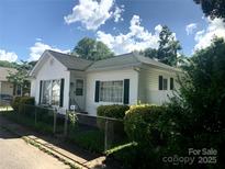 Charming single-story home featuring white siding, green shutters, and a well-maintained front yard at 447 17Th St, Cramerton, NC 28032