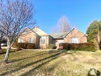 Charming single-story brick home featuring a well-manicured lawn and mature landscaping at 472 Windsor Dr, Taylorsville, NC 28681
