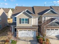 Charming townhome with a two-car garage, stone accents, neutral siding, and well-maintained landscaping at 5062 Gribble Ln, Lancaster, SC 29720