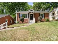 Charming brick home with a well-maintained lawn and a welcoming entrance, complete with a decorative wreath at 534 W Kingston Ave, Charlotte, NC 28203