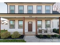 Charming two-story home featuring a covered porch with wooden columns and a landscaped front yard at 5413 Austin Rd # 4, Monroe, NC 28112
