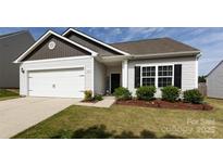 Charming single-story home featuring a two-car garage, well-maintained lawn and attractive landscaping at 7315 Amberly Hills Rd, Charlotte, NC 28215