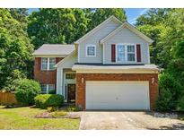 Charming two-story home featuring a brick and vinyl exterior, attached two-car garage, and well-manicured landscaping at 8744 Barrister Way, Charlotte, NC 28216