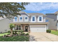 Charming two-story home featuring a well-manicured lawn and an attached two-car garage at 8916 Inverness Bay Rd, Charlotte, NC 28278