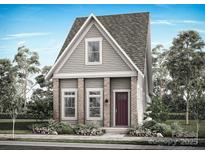 Charming two-story home featuring a cozy front porch and landscaped yard, showcasing a blend of traditional and modern design elements at 9105 Maybry Park St # Lot 114, Charlotte, NC 28212