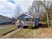 Charming one-story home featuring a cozy front porch and a classic blue exterior at 926 Cantwell St, Charlotte, NC 28208