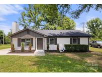 Charming single-story home with a painted brick facade, dark shutters, and a manicured front lawn at 1067 Winchester Dr, Rock Hill, SC 29730