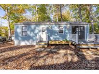 Charming light blue home with a small deck and mature trees in a peaceful setting at 108 Sailors Ct # 108 B, Mount Gilead, NC 27306