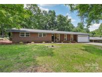 Charming single-story brick home with manicured lawn, mature trees, and attached two-car garage at 1192 Carolyn Dr # 9, Albemarle, NC 28001