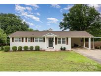 Charming white brick ranch-style home with a well-maintained lawn and covered parking at 127 Leonidas St, Fort Mill, SC 29715