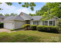 Charming home with manicured lawn and mature landscaping at 1321 Land Grant Rd, Charlotte, NC 28217