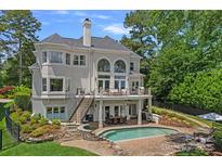 Stunning home featuring a pool, patio, balcony, lush landscaping, and plenty of room for outdoor entertaining at 17938 John Connor Rd, Cornelius, NC 28031