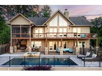 Expansive rear exterior featuring a pool, patio with firepit, covered decks, and stone pillar supports at 204 Ridge Dr # 12 12-1 12-2, Troy, NC 27371
