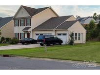 Charming two-story home with red shutters, attached garages and well-maintained lawn at 2061 Argentum Ave # 98, Fort Mill, SC 29707