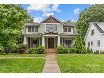 Charming two-story home with a beautiful front porch and manicured landscaping at 2414 Bay St, Charlotte, NC 28205