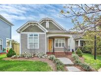Charming home featuring a yellow front door, landscaped yard, and inviting curb appeal at 6705 E Douglas Park Dr, Huntersville, NC 28078