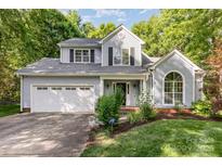 Charming two-story home with a well-maintained lawn, attached garage, and welcoming front porch at 7226 Reedy Creek Rd, Charlotte, NC 28215