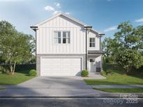 Charming two-story home boasts a stone-accented garage and a well-manicured lawn at Lot 14 Contentment Ct # 14, Kannapolis, NC 28083