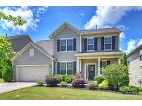Charming two-story home featuring well-manicured lawn, attached garage and beautiful landscaping at 11101 Crane Creek Dr, Charlotte, NC 28278