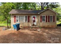 Charming tan single-story home with red shutters and front yard at 208 N School St, Mount Gilead, NC 27306