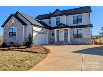 Charming two-story home with a combination of light gray siding and stone accents, complemented by a two-car garage at 2092 Fordhill St, Rock Hill, SC 29732