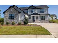 Beautiful two-story home with stone and siding, complemented by a lush green lawn at 2092 Fordhill St, Rock Hill, SC 29732