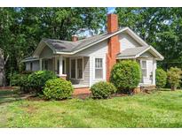 Charming single-Gathering home with a well-manicured front yard and inviting curb appeal at 24515 Saint Martin Rd, Albemarle, NC 28001