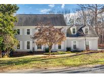 Charming two-story home with a well-manicured lawn, gray siding, white shutters and dormer windows at 2702 Oxborough Dr, Matthews, NC 28105