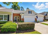 Charming townhome with manicured front yard and two-car garage, offering classic appeal at 31415 Royal Tern Ln, Fort Mill, SC 29707